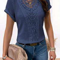 Ancient Energy blue hollow-out short-sleeve lace top with intricate neckline, paired with jeans