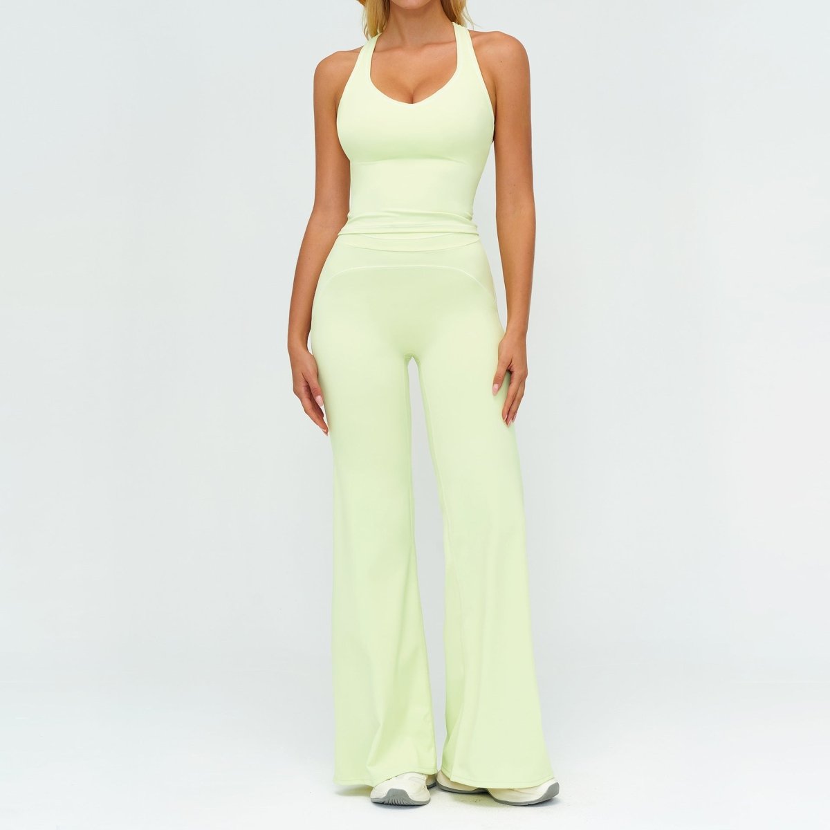 Ancient Energy women's yoga set: V-neck sleeveless top with slim straight pants in pale lime.