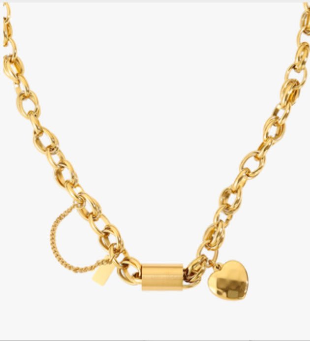 Gold-tone bracelet with a heart-shaped pendant on a chunky chain