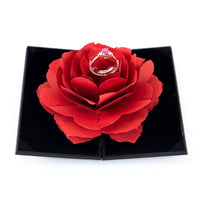 3D Love Box heart-shaped rose rotating ring box with pink gemstone ring on red petals in black presentation box