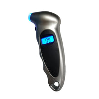 Smart Tire Pressure Monitor handheld gauge with gray metallic body and blue backlit LCD displaying 0.0 psi.