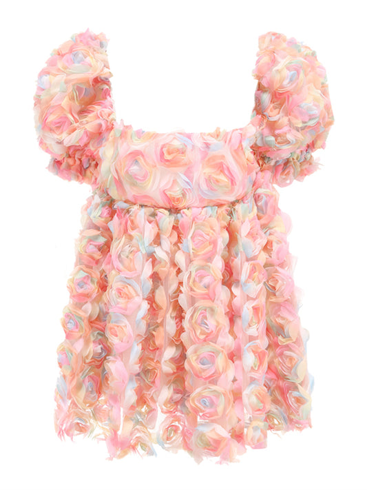 Ladies' blush floral puff sleeve mini dress by Mandotos International, featuring a feminine floral pattern and puff sleeves.