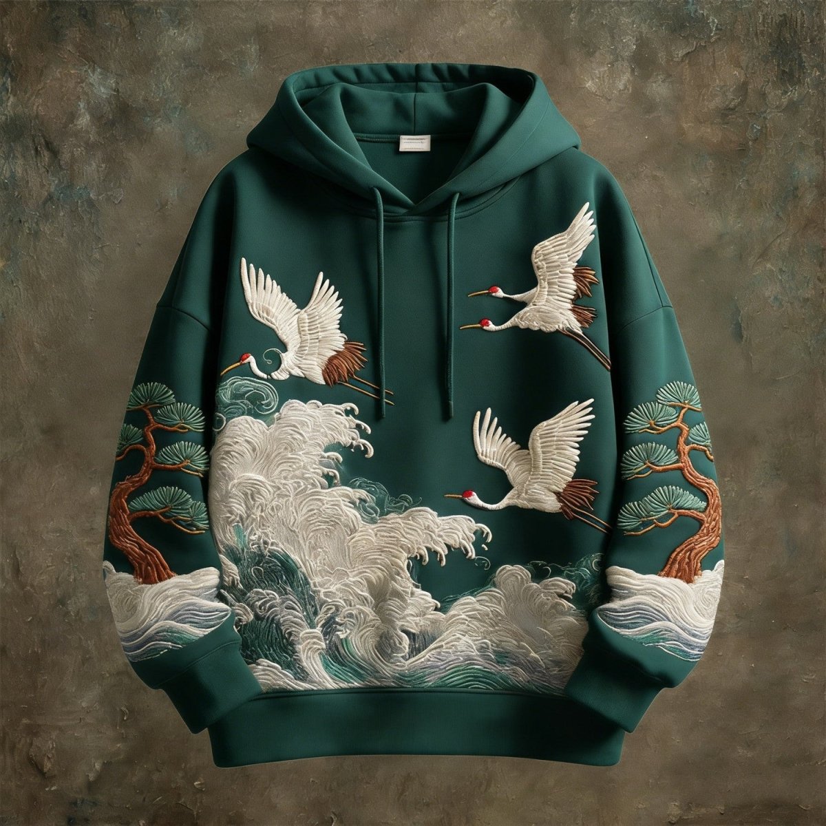 Hoodie by Ancient Energy in forest green with embroidered cranes, waves and pines.