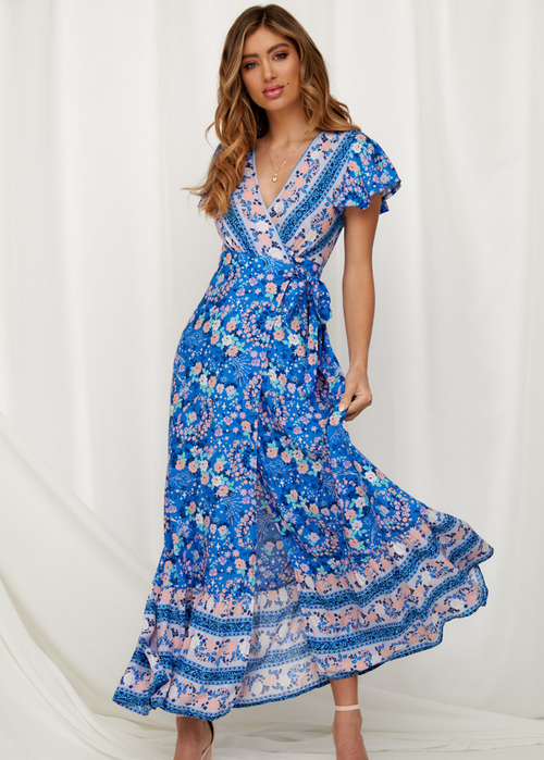 Mandotos International Tropical Bloom Maxi Dress with vibrant floral pattern and flowing fabric, perfect for summer occasions.