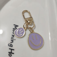 Cross-border e-commerce alloy color dripping smiley face keychain electroplated gold irregular expression bag pendant accessories