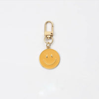 Cross-border e-commerce alloy color dripping smiley face keychain electroplated gold irregular expression bag pendant accessories