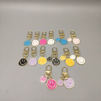 Cross-border e-commerce alloy color dripping smiley face keychain electroplated gold irregular expression bag pendant accessories