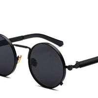Round black sunglasses with dark lenses, slim metal rims, and black temples; vintage steampunk style.
