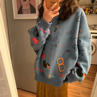 Blue oversized Chic Loose Women's Thick Long Sleeve Sweatshirt Dress with abstract doodles worn by a woman.