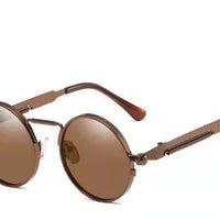 Bronze metal frame with round brown lenses, tan leather-accented temples, vintage steampunk sunglasses.