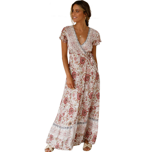 Mandotos International Tropical Bloom Maxi Dress featuring vibrant floral patterns and flowy fabric on a model.