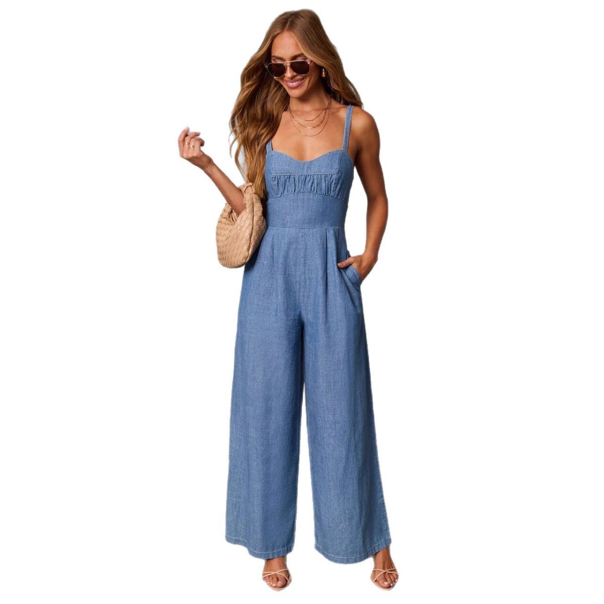 Solid-color casual workwear jumpsuit for women in blue denim, with spaghetti straps and pockets