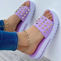 Women's pair of wedge rivet beach flip-flops in lavender purple by Ancient Energy, with gold studded straps