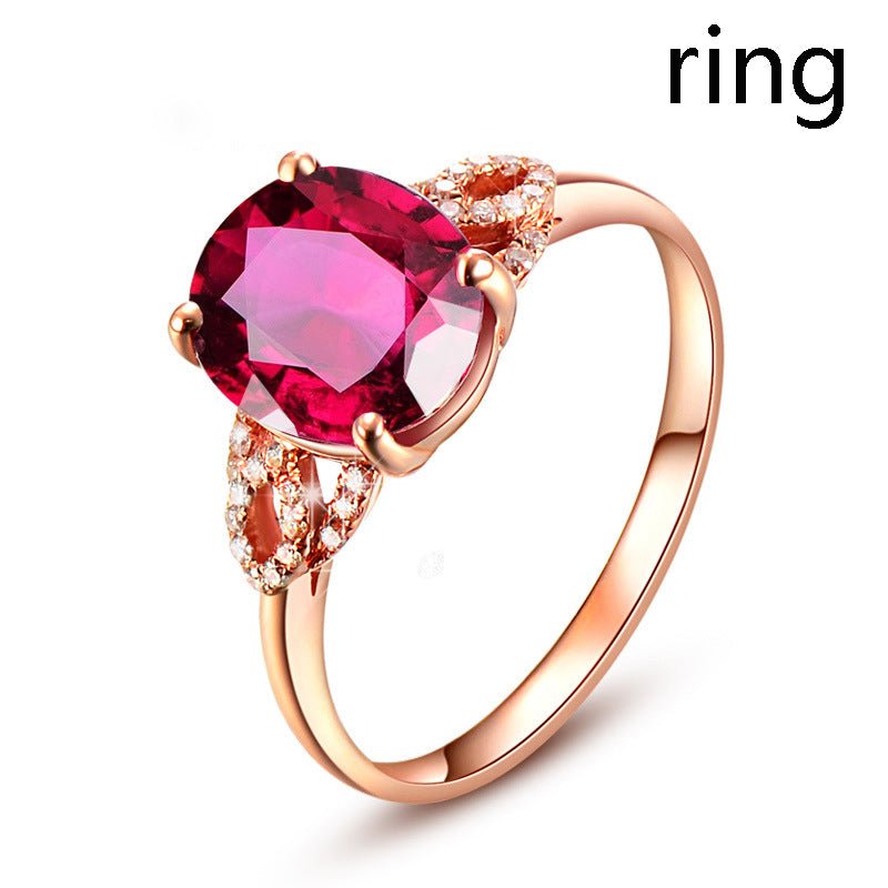Ring by Ancient Energy in rose-gold with a large red gemstone and pavé diamonds on the band