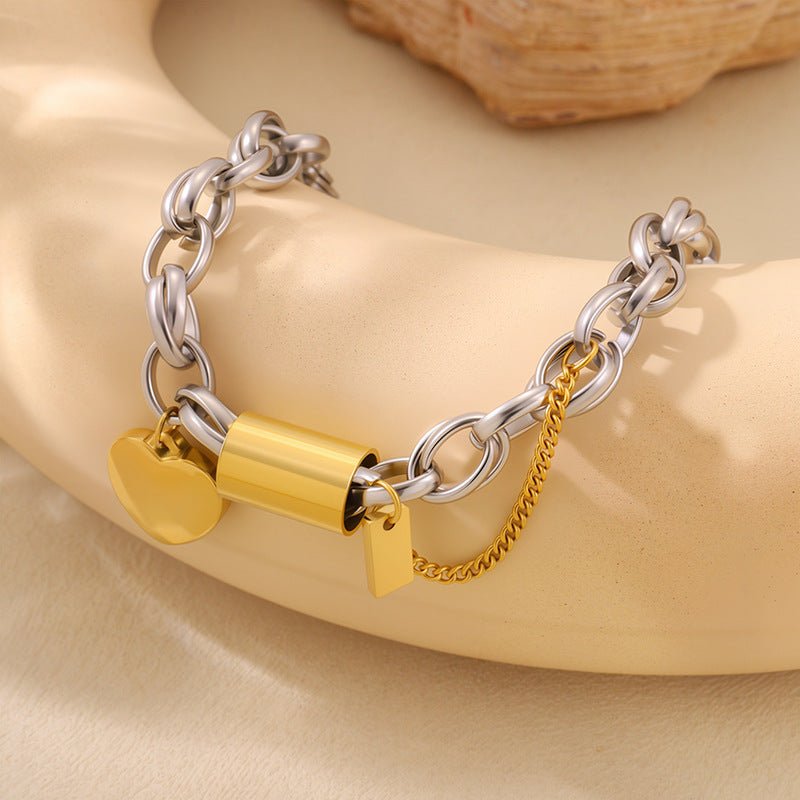 Versatile titanium bracelet with silver chain, gold heart pendant and padlock charm