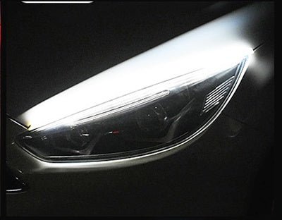 Ancient Energy Car LED Daytime Running Light Strip with turn signal LEDs, installed on vehicle for enhanced visibility.