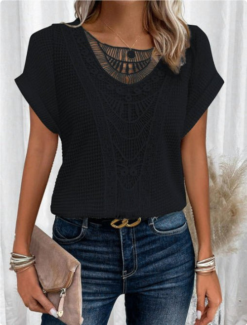 Summer hollow-out short-sleeve black top with intricate crochet pattern, paired with denim jeans