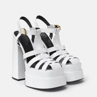 White platform sandals with thick block heels, multiple straps and ankle buckle