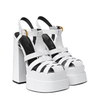 White strappy platform sandals with thick block heels and ankle buckles by Ancient Energy