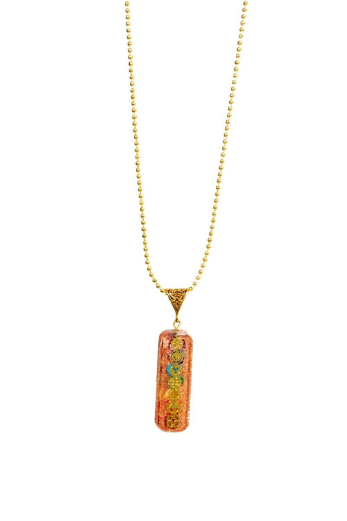 Seven chakra orgone copper pendant with chain, featuring colorful chakra symbols and a polished finish, designed for energy balancing.