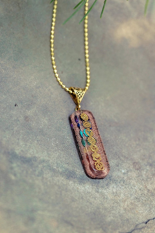 7 chakra Orgone copper pendant with chain from Ancient Energy, featuring colorful chakra stones and intricate metalwork.
