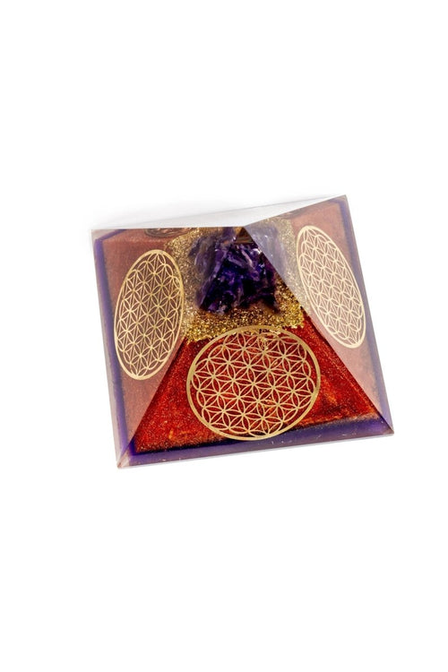 Ancient Energy Flower of Life copper orgone pyramid with amethyst crystal, featuring intricate design and vibrant purple gemstone.