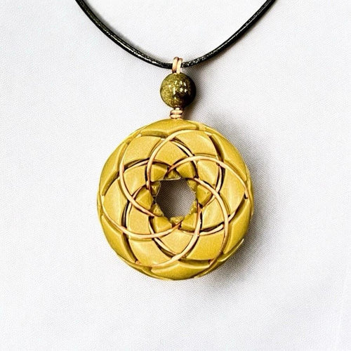 Brass and Libyan Desert Glass Torus Vortex Pendant necklace with Rodin Coil, crafted by Ancient Energy, featuring orgonite elements.