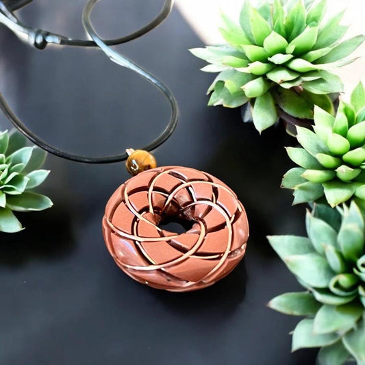 Tigers eye torus vortex pendant necklace with copper orgonite and Rodin coil by Ancient Energy, displayed on a neutral background.