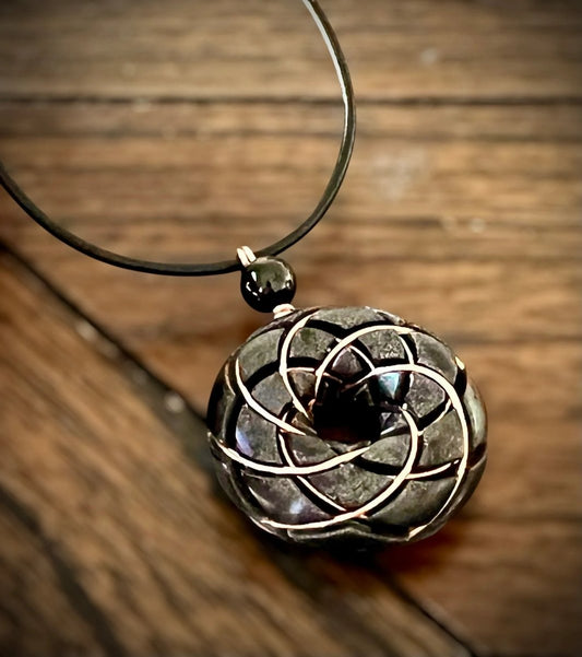 Ancient Energy Torus Vortex pendant necklace with shungite orgonite and Rodin coil, featuring a sleek, handcrafted design.