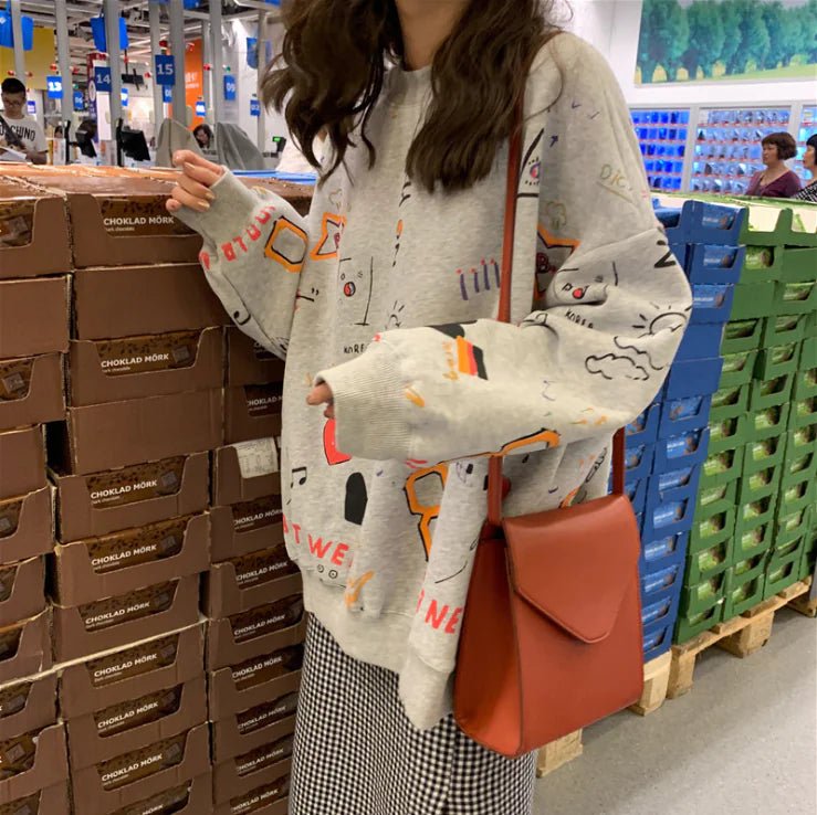 Woman in gray oversized Chic Loose Thick Long Sleeve Sweatshirt Dress with colorful graphics and orange crossbody bag.