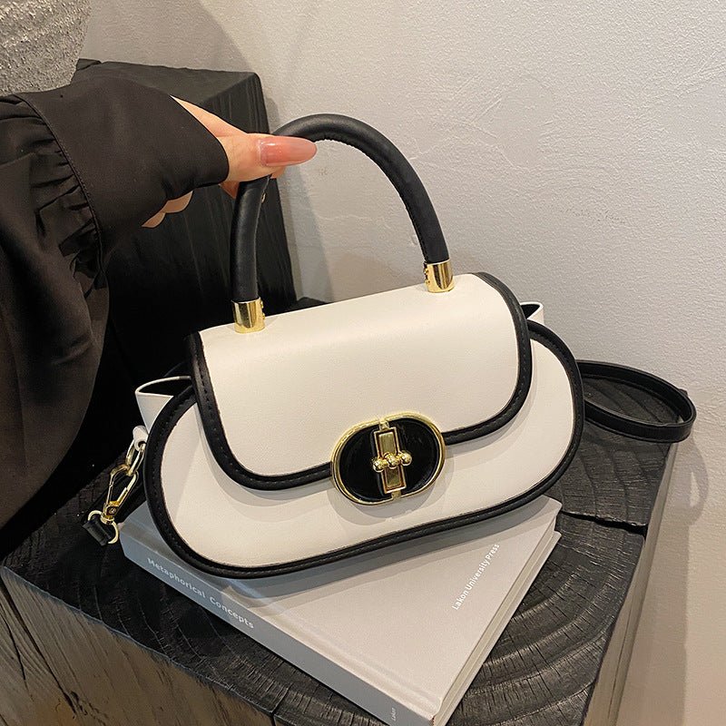 Premium retro matte tote bag with black trim and gold hardware, cream body, top handle.