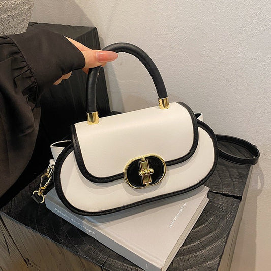 Premium retro matte tote bag with black trim and gold hardware, cream body, top handle.