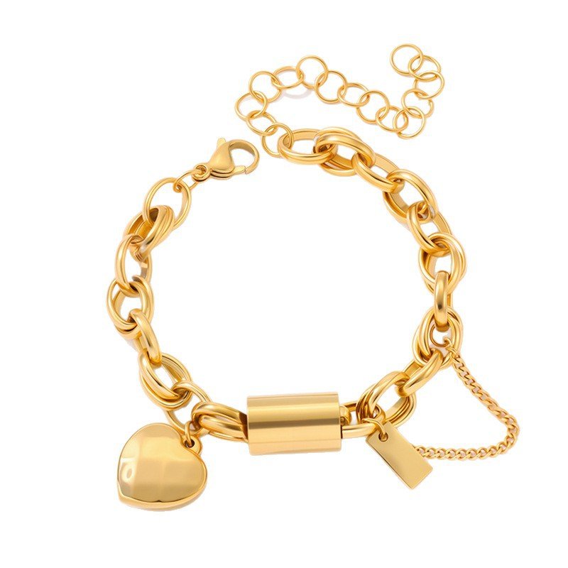 Bracelet: Titanium heart-pendant with gold-tone chain links, lobster clasp, and safety chain