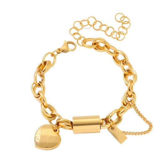Bracelet: Titanium heart-pendant with gold-tone chain links, lobster clasp, and safety chain