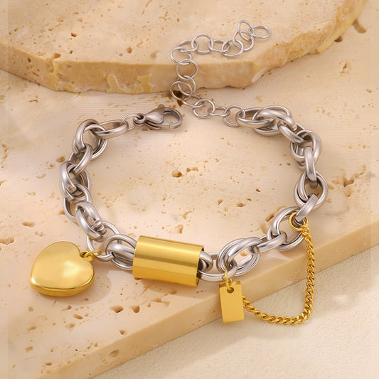 Titanium bracelet with heart-shaped pendant and gold-tone accents by Ancient Energy