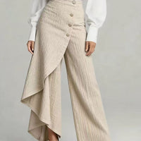 Ancient Energy beige textured straight-leg pants with front button row and draped asymmetric wrap overlay