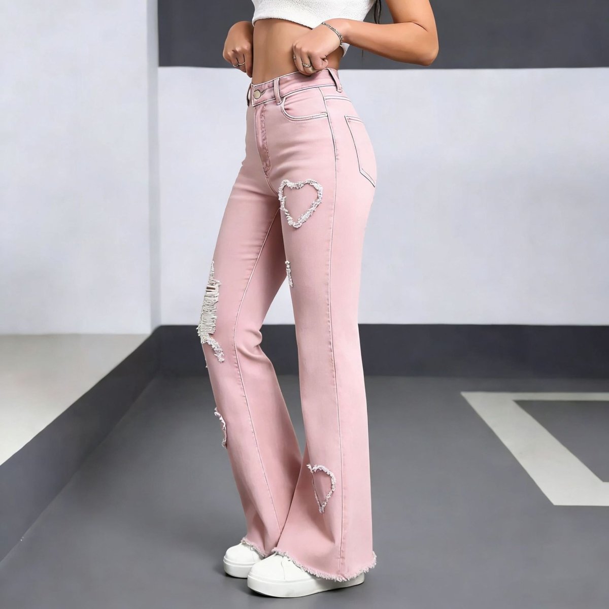 Stylish casual denim jeans for women in pink with distressed heart patches and frayed hems