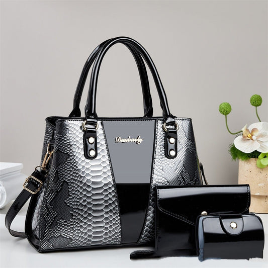 Large-capacity shouldercrossbody bag by Ancient Energy with snakeskin pattern; black/gray leather; includes wallet.