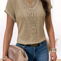 Beige summer hollow-out short-sleeve knit top with lace neckline; worn with blue jeans and a pleated beige clutch
