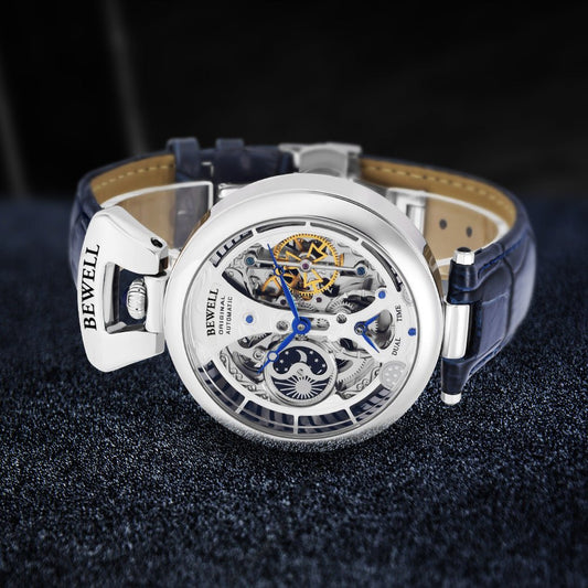Mens skeleton watch with blue leather strap and silver case; Bewell branding visible.