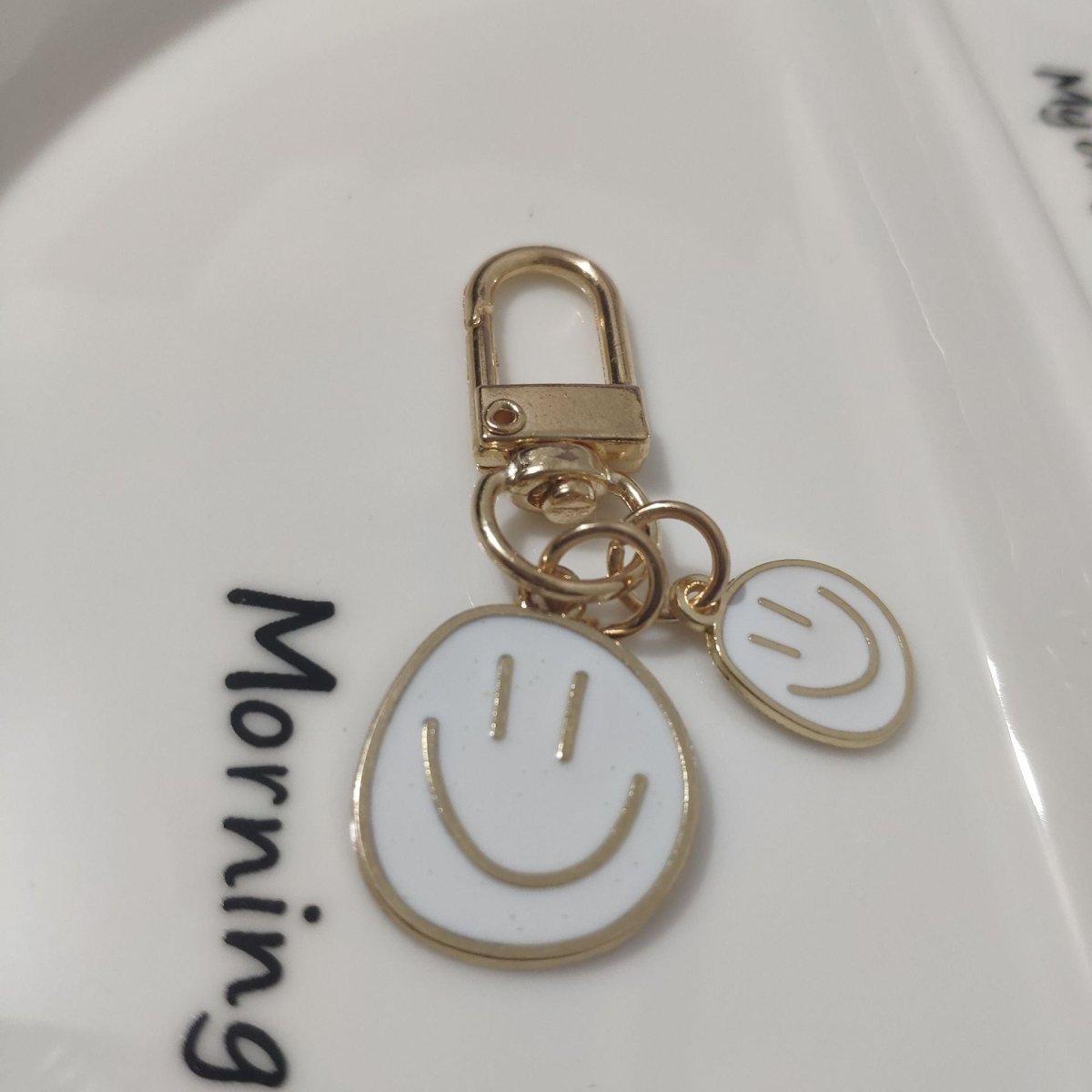Cross-border e-commerce alloy color dripping smiley face keychain electroplated gold irregular expression bag pendant accessories - MANDOTOS INTERNATIONAL