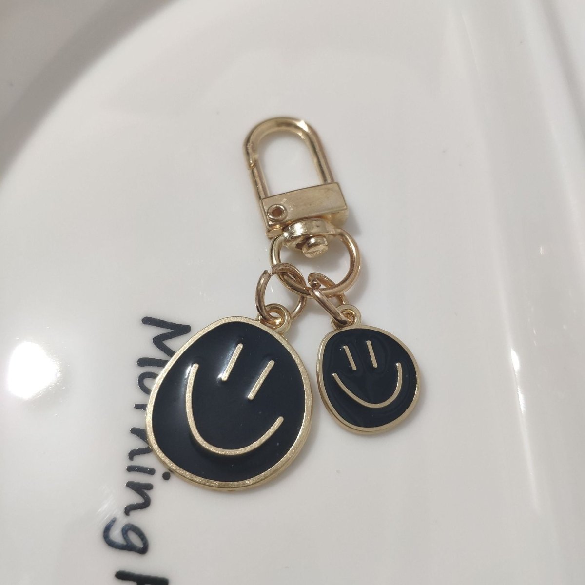 Cross-border e-commerce alloy color dripping smiley face keychain electroplated gold irregular expression bag pendant accessories - MANDOTOS INTERNATIONAL