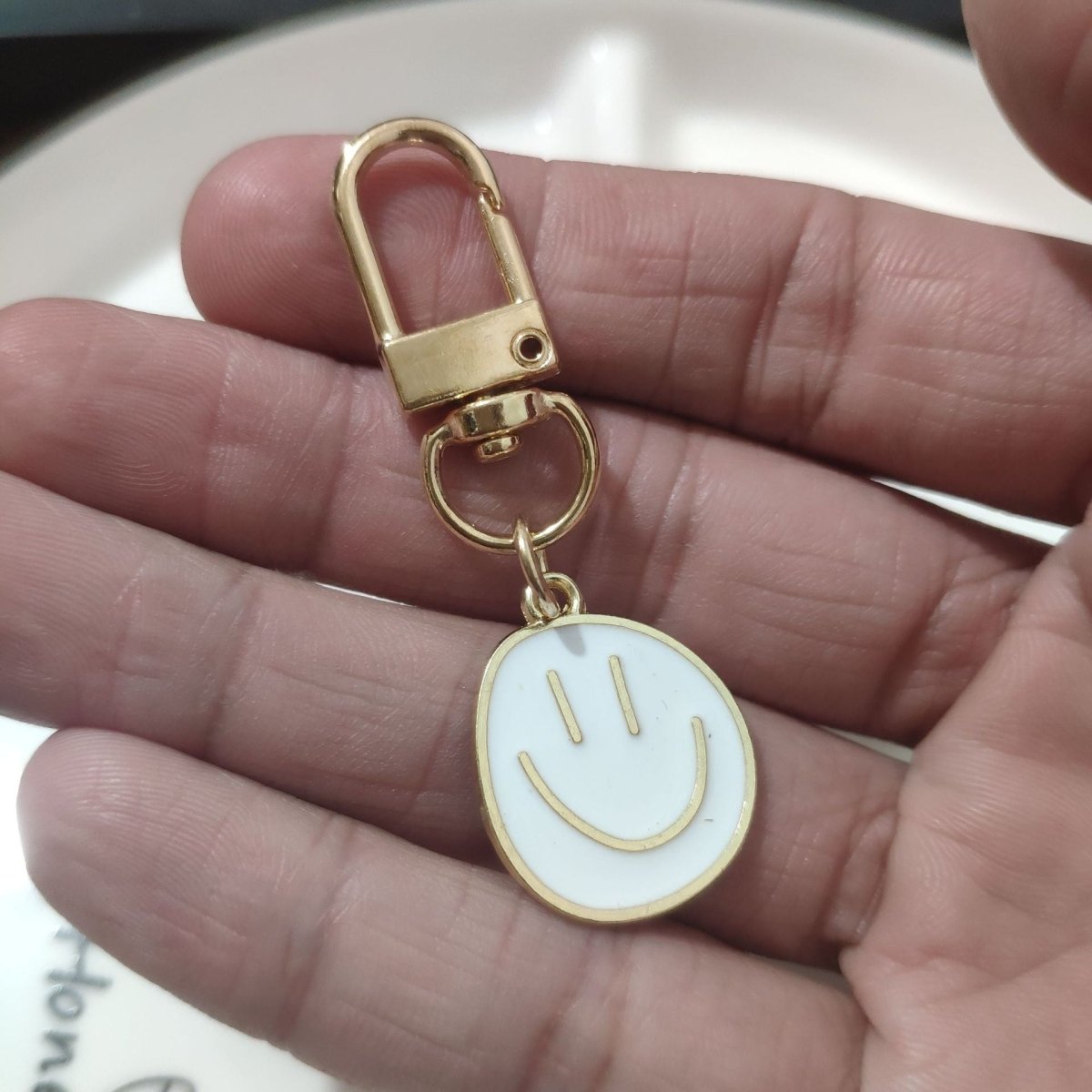 Cross-border e-commerce alloy color dripping smiley face keychain electroplated gold irregular expression bag pendant accessories - MANDOTOS INTERNATIONAL