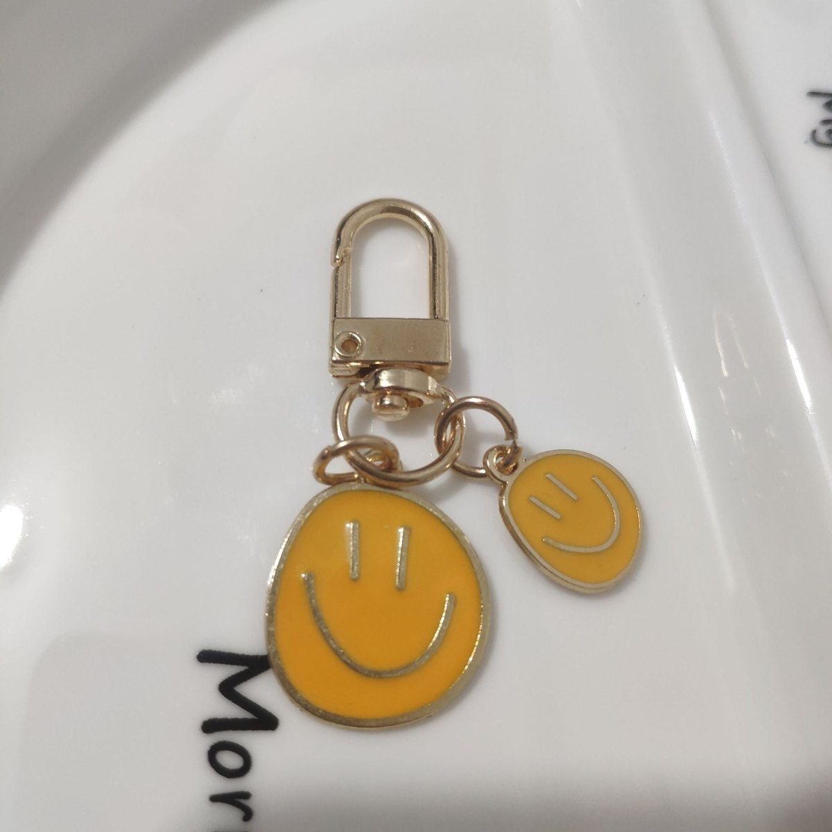 Cross-border e-commerce alloy color dripping smiley face keychain electroplated gold irregular expression bag pendant accessories - MANDOTOS INTERNATIONAL