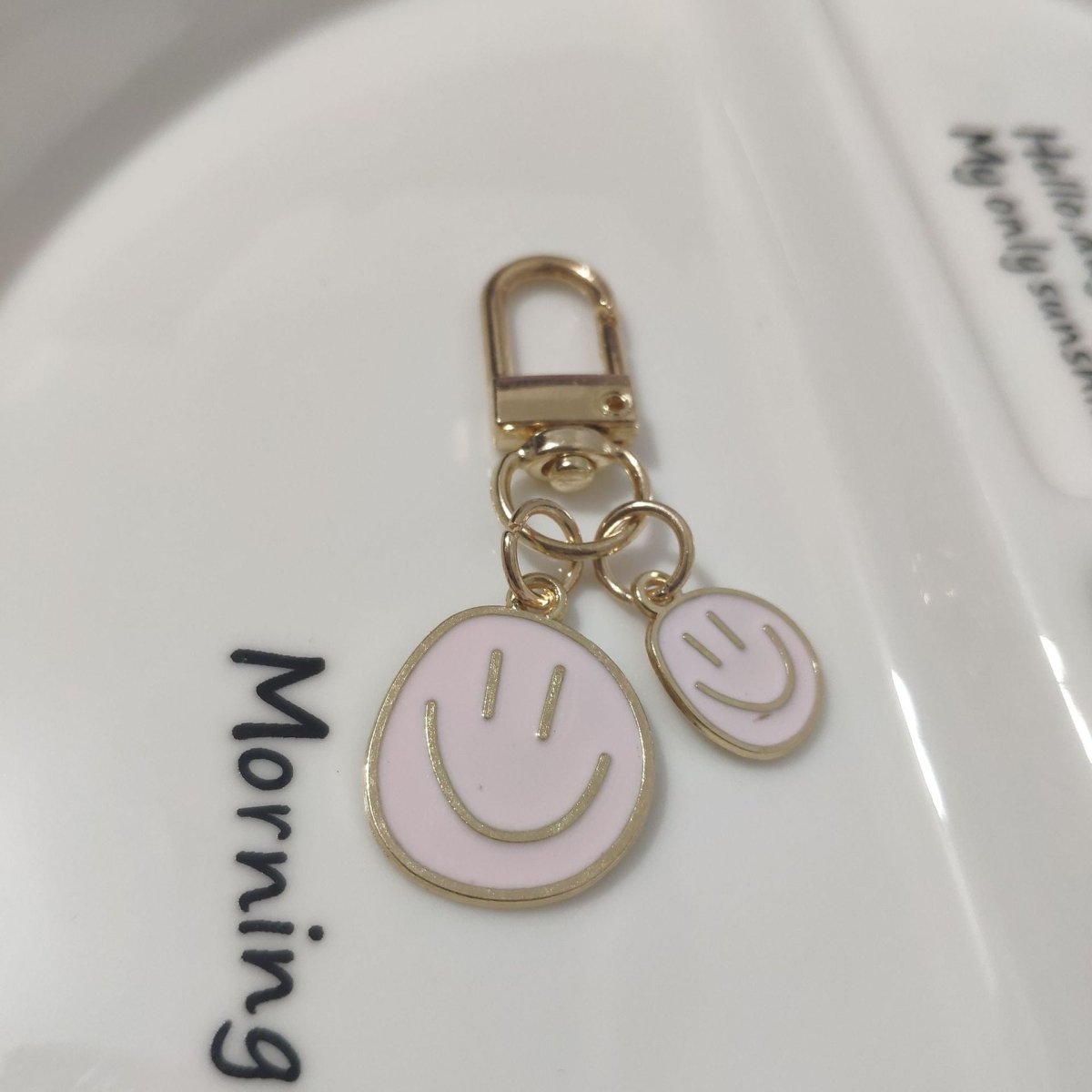 Cross-border e-commerce alloy color dripping smiley face keychain electroplated gold irregular expression bag pendant accessories - MANDOTOS INTERNATIONAL