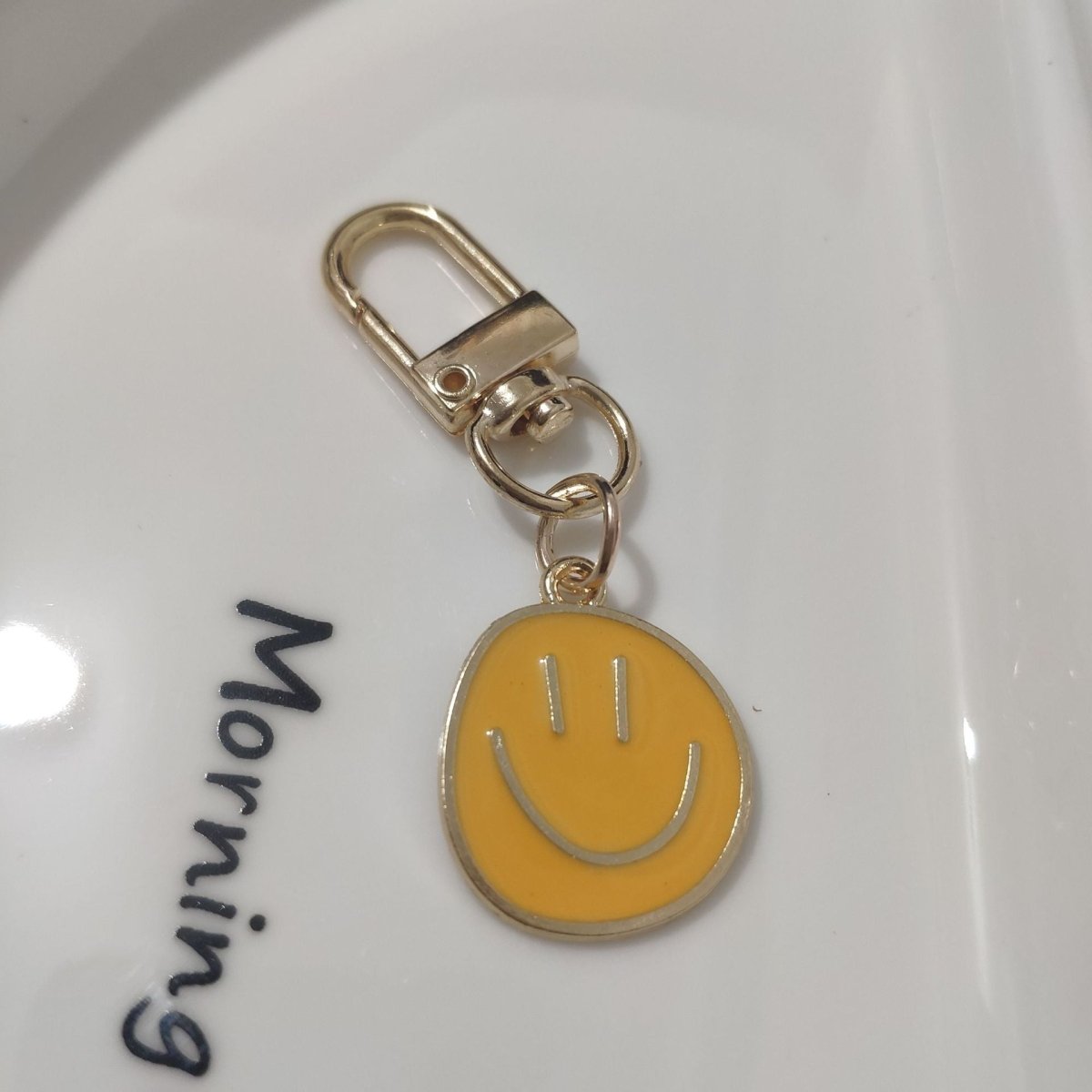 Cross-border e-commerce alloy color dripping smiley face keychain electroplated gold irregular expression bag pendant accessories - MANDOTOS INTERNATIONAL