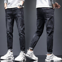 Mens ripped denim jeans with cat-whisker scratches, dark wash, Ancient Energy, shown as two pairs with rolled cuffs.