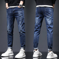 Mens ripped denim jeans with cat-whisker scratches, Ancient Energy, dark blue distressed denim, front and back views.