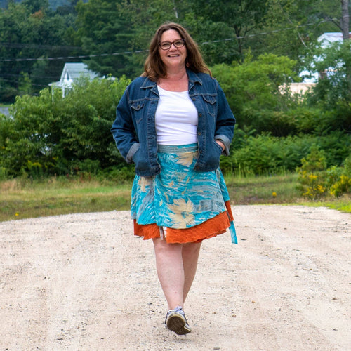 Knee-length mini sari wrap skirt by Darn Good Yarn in warm tones, showcasing colorful fabric and stylish wrap design.