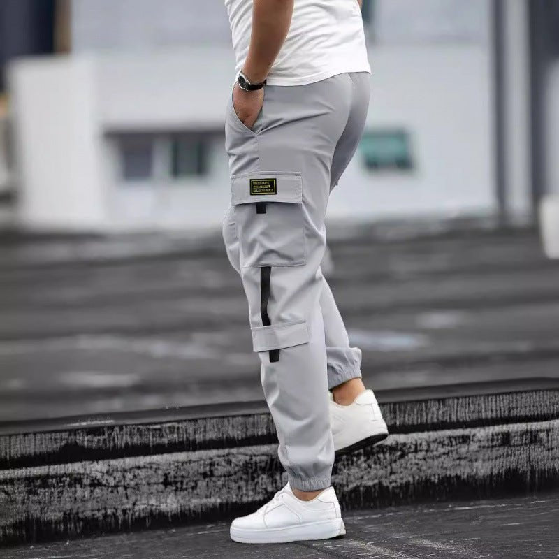 Mens retro jogger cargo pants in light gray with cargo pockets and strap details by Ancient Energy.